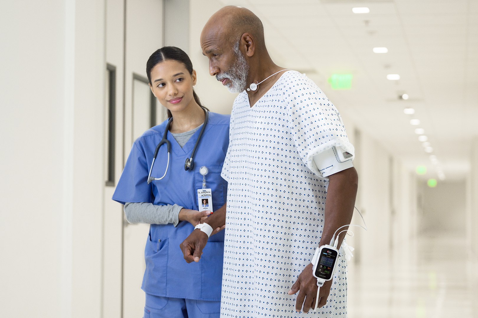 healthcare worker assisting patient wearing  radius vsm on wrist